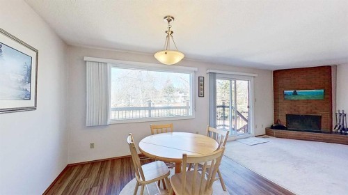 5801/5803 Dalgleish Road Nw, Calgary, AB - Indoor Photo Showing Dining Room With Fireplace