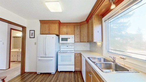 5801/5803 Dalgleish Road Nw, Calgary, AB - Indoor Photo Showing Kitchen With Double Sink