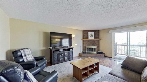 5801/5803 Dalgleish Road Nw, Calgary, AB - Indoor Photo Showing Living Room With Fireplace