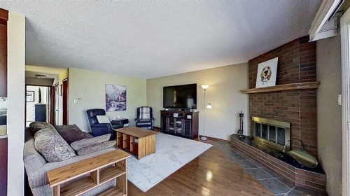 5801/5803 Dalgleish Road Nw, Calgary, AB - Indoor Photo Showing Living Room With Fireplace