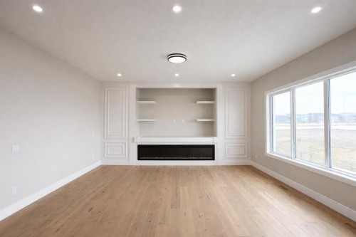 852 Dawson Point, Chestermere, AB - Indoor Photo Showing Other Room With Fireplace