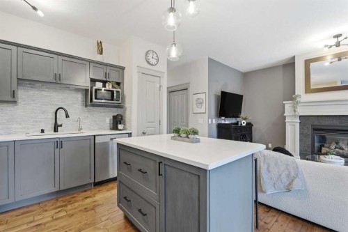 54 Wentworth Common Sw, Calgary, AB - Indoor Photo Showing Kitchen With Fireplace