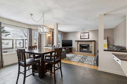 168 Erin Meadow Close Se, Calgary, AB - Indoor Photo Showing Dining Room With Fireplace