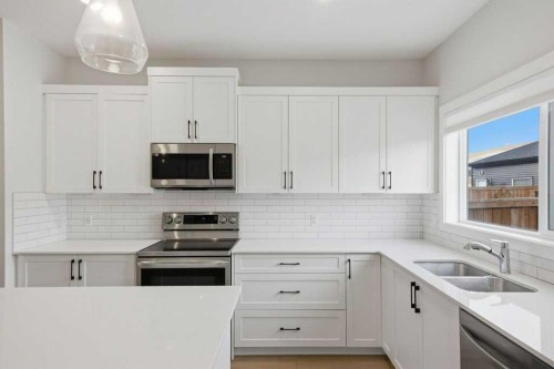 311 Wolf Creek Way Se, Calgary, AB - Indoor Photo Showing Kitchen With Stainless Steel Kitchen With Double Sink With Upgraded Kitchen