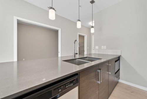 407-122 Mahogany Centre Se, Calgary, AB - Indoor Photo Showing Kitchen With Double Sink With Upgraded Kitchen