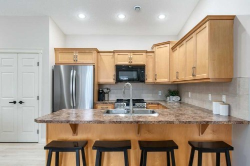 401 Sunvale Crescent Ne, High River, AB - Indoor Photo Showing Kitchen With Double Sink