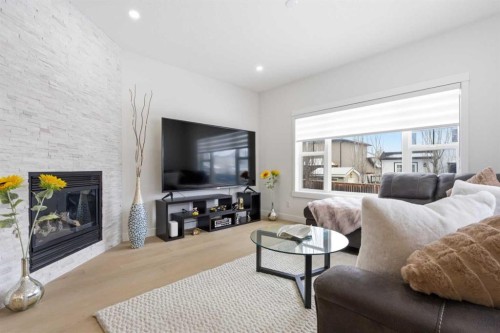 103 Oakmere Green, Chestermere, AB - Indoor Photo Showing Living Room With Fireplace