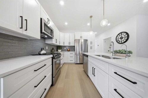 103 Oakmere Green, Chestermere, AB - Indoor Photo Showing Kitchen With Stainless Steel Kitchen With Double Sink With Upgraded Kitchen