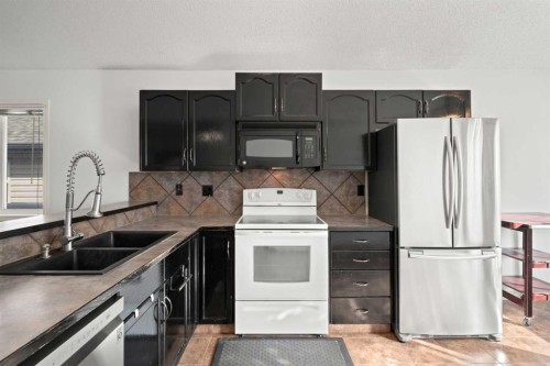 145 Cimarron Grove Circle, Okotoks, AB - Indoor Photo Showing Kitchen With Double Sink