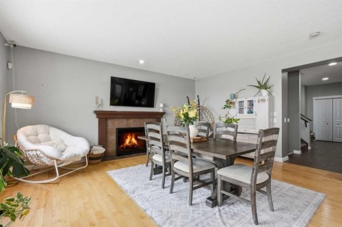 99 Sunset View, Cochrane, AB - Indoor Photo Showing Dining Room With Fireplace