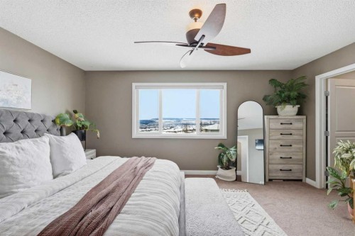 99 Sunset View, Cochrane, AB - Indoor Photo Showing Bedroom