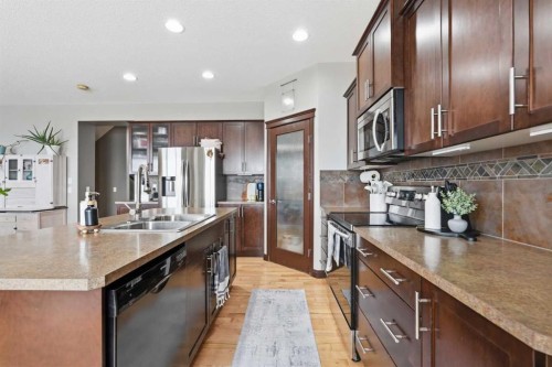 99 Sunset View, Cochrane, AB - Indoor Photo Showing Kitchen With Stainless Steel Kitchen With Double Sink