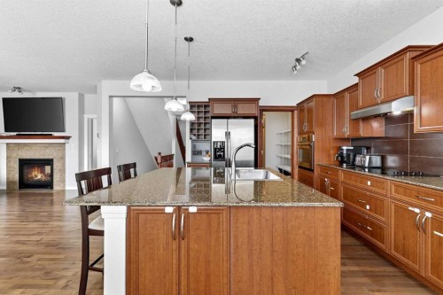 38 Silverado Skies Crescent, Calgary, AB - Indoor Photo Showing Kitchen With Fireplace