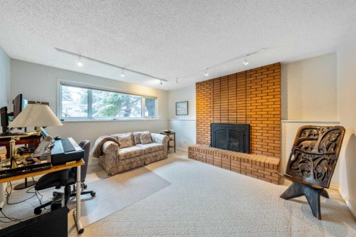 3316 24 Street Nw, Calgary, AB - Indoor Photo Showing Living Room With Fireplace