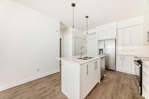 2309-63 Corner Glen Crescent Ne, Calgary, AB - Indoor Photo Showing Kitchen With Stainless Steel Kitchen With Double Sink With Upgraded Kitchen