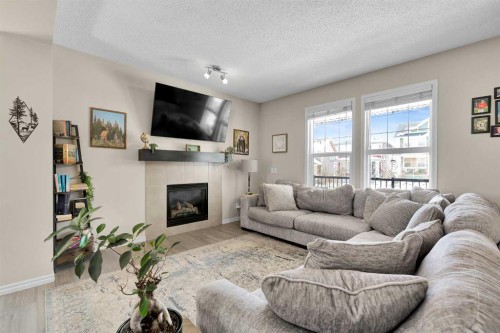 151 Heritage Drive, Cochrane, AB - Indoor Photo Showing Living Room With Fireplace
