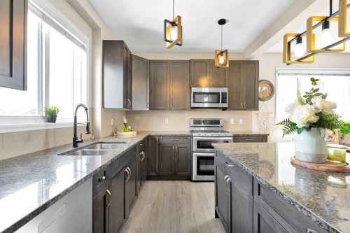 151 Heritage Drive, Cochrane, AB - Indoor Photo Showing Kitchen With Stainless Steel Kitchen With Double Sink With Upgraded Kitchen