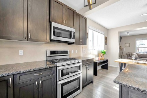 151 Heritage Drive, Cochrane, AB - Indoor Photo Showing Kitchen With Upgraded Kitchen