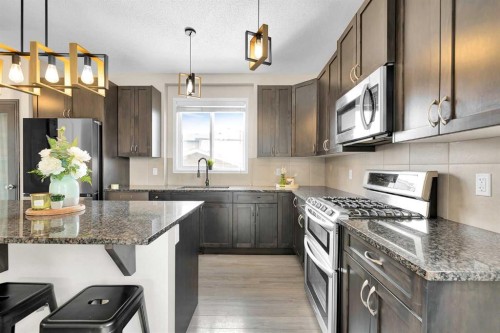 151 Heritage Drive, Cochrane, AB - Indoor Photo Showing Kitchen With Upgraded Kitchen
