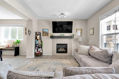 151 Heritage Drive, Cochrane, AB - Indoor Photo Showing Living Room With Fireplace