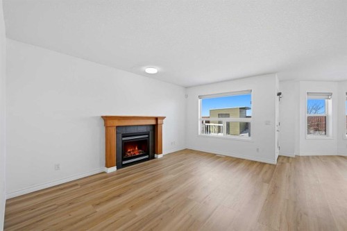 165 Saddlecrest Way Ne, Calgary, AB - Indoor Photo Showing Living Room With Fireplace