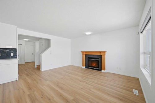 165 Saddlecrest Way Ne, Calgary, AB - Indoor Photo Showing Living Room With Fireplace