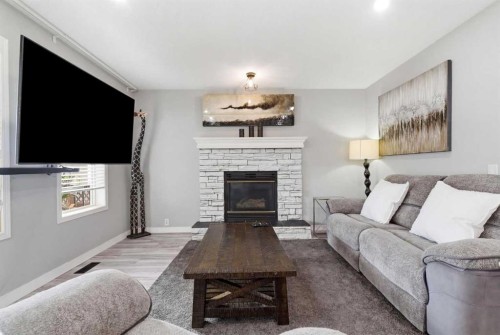 23 Prestwick Green Se, Calgary, AB - Indoor Photo Showing Living Room With Fireplace