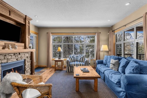 202-3 Aspen Glen, Canmore, AB - Indoor Photo Showing Living Room With Fireplace