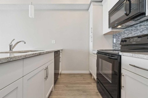 9205-101 Sunset Drive, Cochrane, AB - Indoor Photo Showing Kitchen