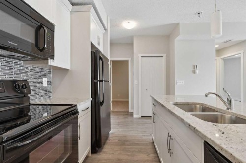 9205-101 Sunset Drive, Cochrane, AB - Indoor Photo Showing Kitchen With Double Sink With Upgraded Kitchen