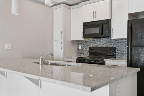 9205-101 Sunset Drive, Cochrane, AB - Indoor Photo Showing Kitchen With Double Sink