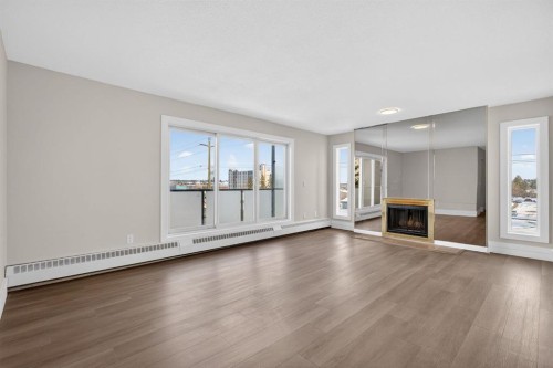 315-335 Garry Crescent Ne, Calgary, AB - Indoor Photo Showing Living Room With Fireplace