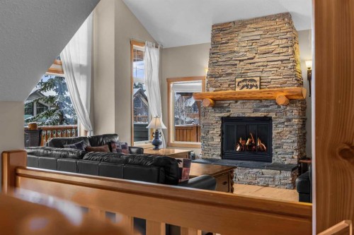 147 Hubman Landing, Canmore, AB - Indoor Photo Showing Living Room With Fireplace