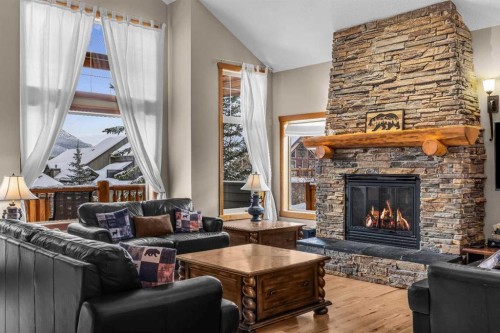 147 Hubman Landing, Canmore, AB - Indoor Photo Showing Living Room With Fireplace