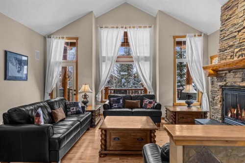 147 Hubman Landing, Canmore, AB - Indoor Photo Showing Living Room With Fireplace