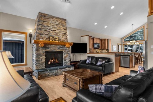 147 Hubman Landing, Canmore, AB - Indoor Photo Showing Living Room With Fireplace