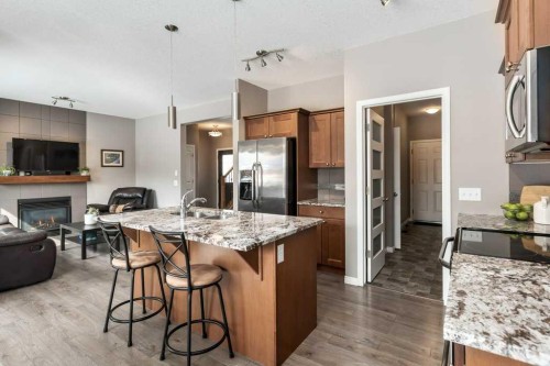 105 Wildrose Green, Strathmore, AB - Indoor Photo Showing Kitchen With Fireplace With Stainless Steel Kitchen With Upgraded Kitchen