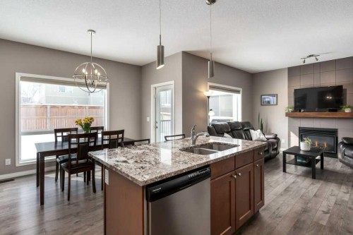 105 Wildrose Green, Strathmore, AB - Indoor Photo Showing Kitchen With Fireplace With Double Sink