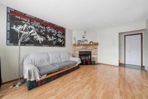 488 Templevale Drive Ne, Calgary, AB - Indoor Photo Showing Living Room With Fireplace