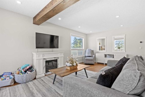 23 Millbank Drive Sw, Calgary, AB - Indoor Photo Showing Living Room With Fireplace