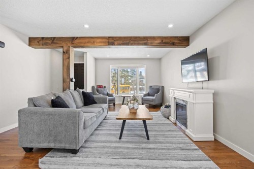 23 Millbank Drive Sw, Calgary, AB - Indoor Photo Showing Living Room With Fireplace