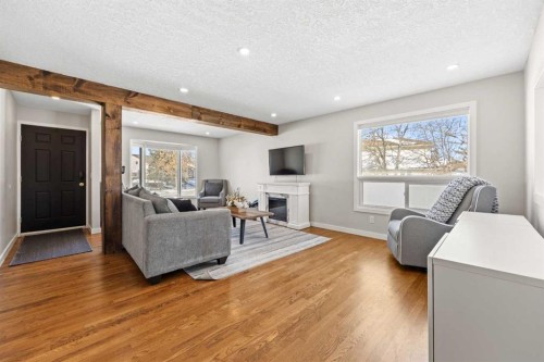 23 Millbank Drive Sw, Calgary, AB - Indoor Photo Showing Living Room With Fireplace