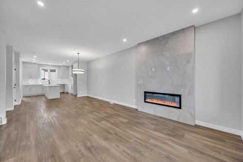 10 Versant Path Sw, Calgary, AB - Indoor Photo Showing Living Room With Fireplace