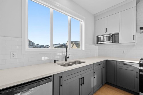 153 Edith Way Nw, Calgary, AB - Indoor Photo Showing Kitchen With Double Sink