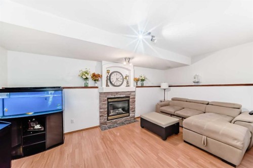 435 Coventry Road Ne, Calgary, AB - Indoor Photo Showing Living Room With Fireplace