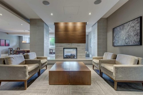 251-222 Riverfront Avenue Sw, Calgary, AB - Indoor Photo Showing Living Room With Fireplace