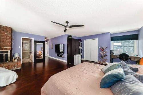 2002 Pump Hill Way Sw, Calgary, AB - Indoor Photo Showing Bedroom With Fireplace