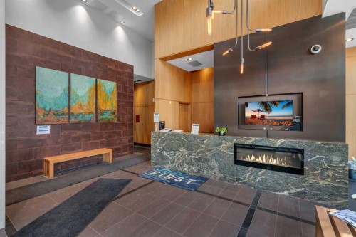 1003-550 Riverfront Avenue Se, Calgary, AB - Indoor Photo Showing Other Room With Fireplace