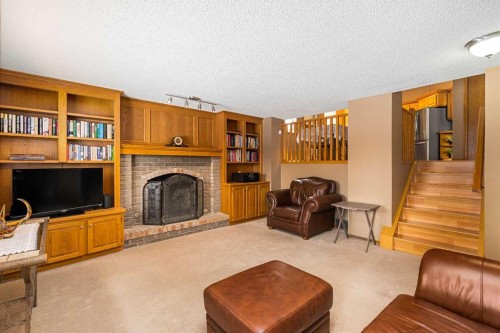184 Sunmeadows Crescent Se, Calgary, AB - Indoor Photo Showing Living Room With Fireplace
