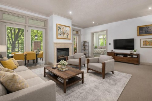 105-670 Princeton Way Sw, Calgary, AB - Indoor Photo Showing Living Room With Fireplace